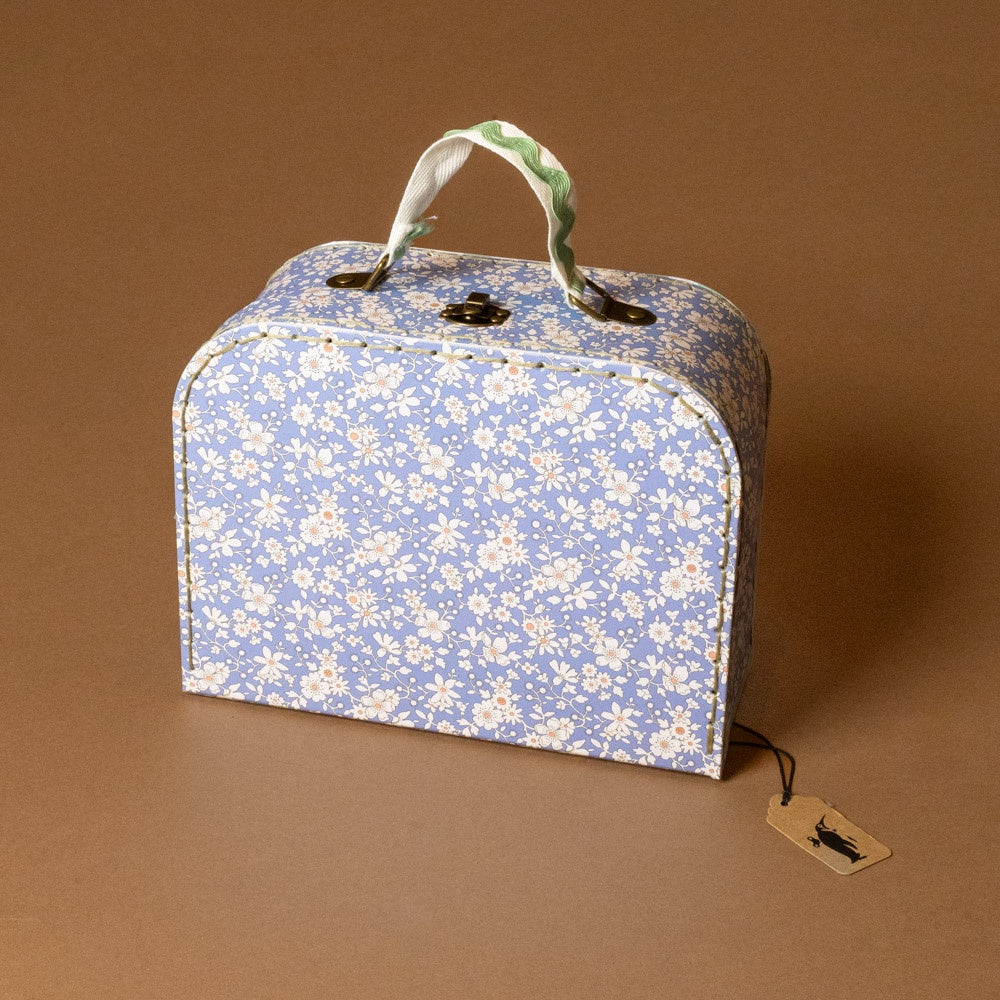 blue Floral-patterned liberty-suitcase-small with a tag on a brown background