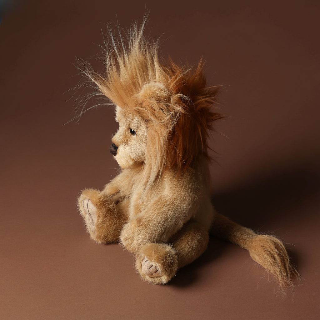 Stuffed lion toy with on a brown background