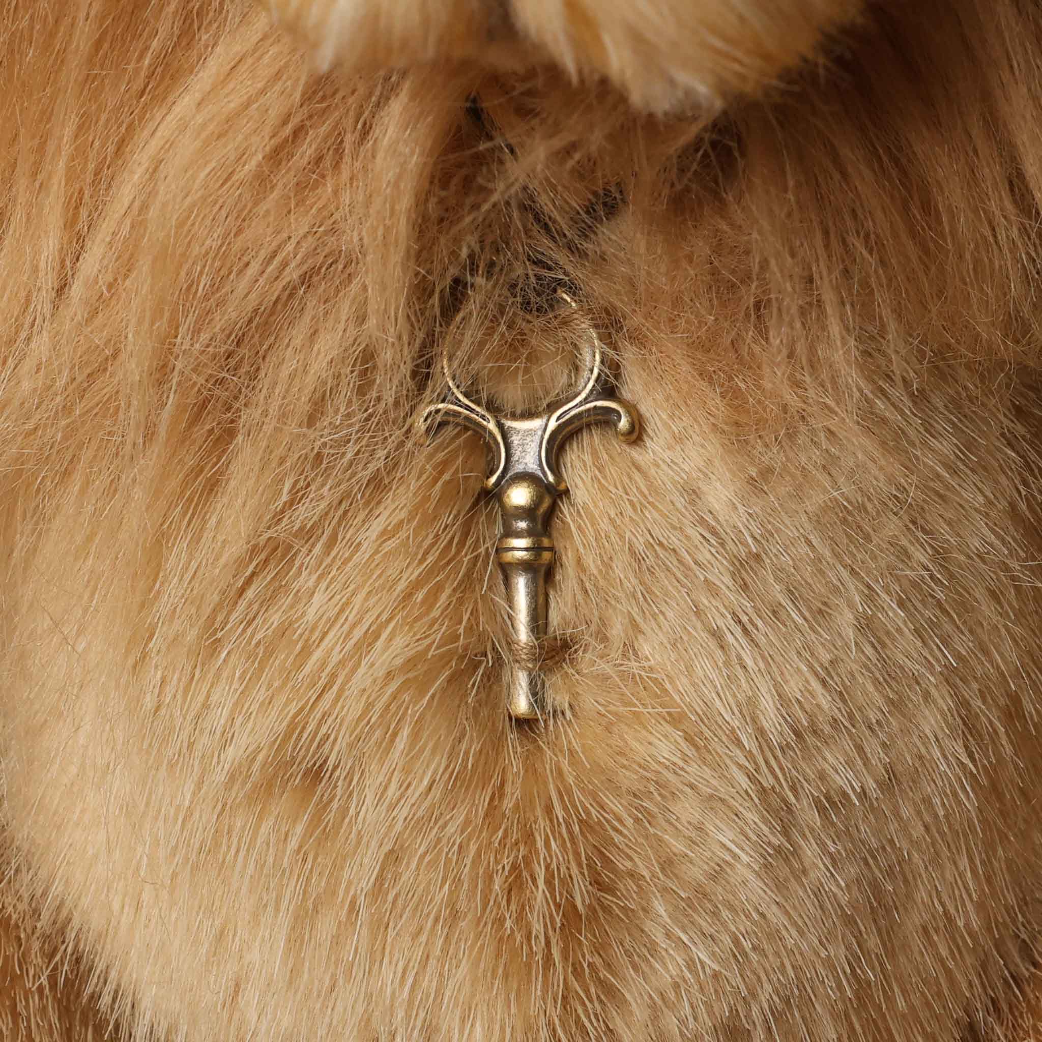 Stuffed lion toy with on a brown background-key-charm