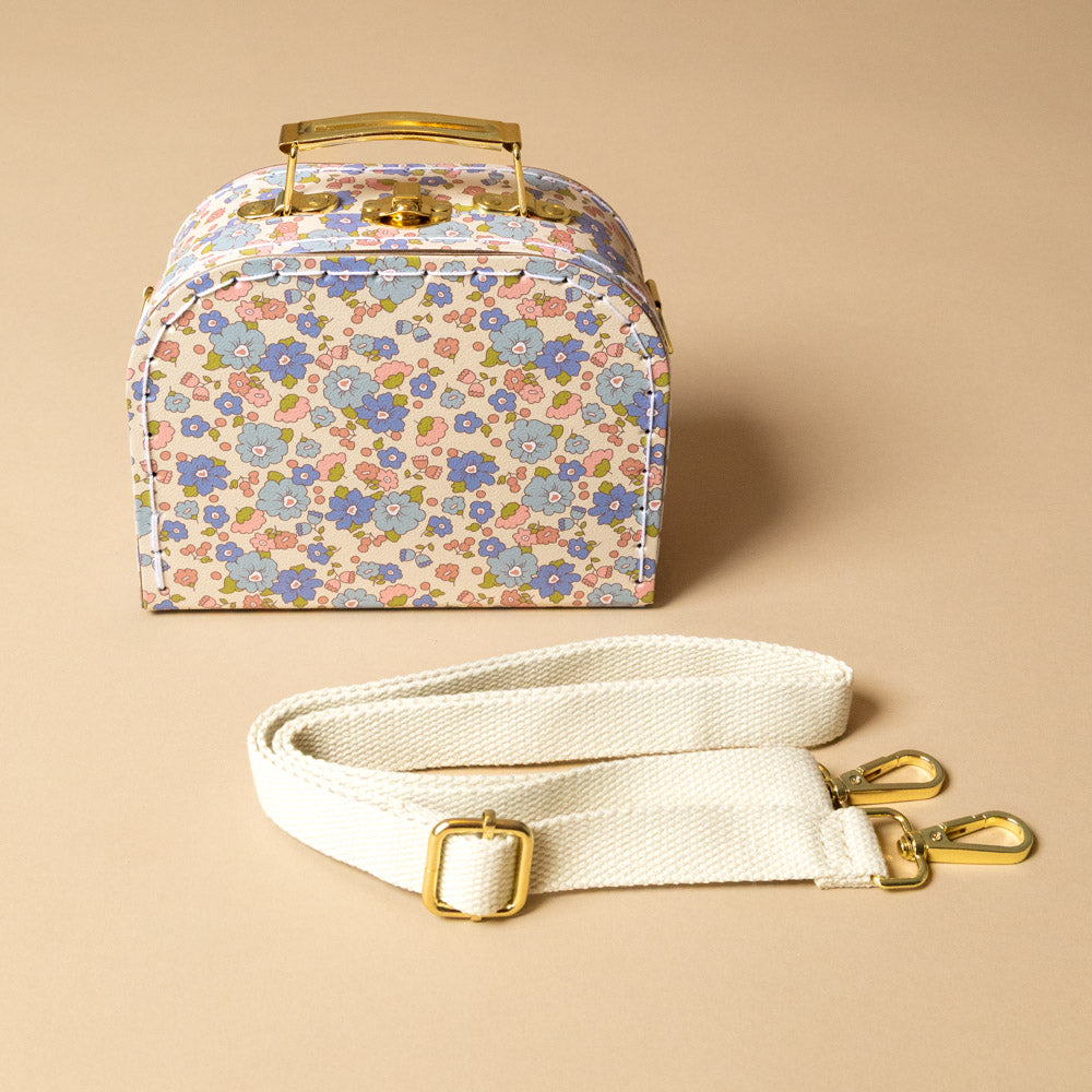 little-cross-body-case-liberty-blue Floral-patterned handbag with a white strap on  a beige background