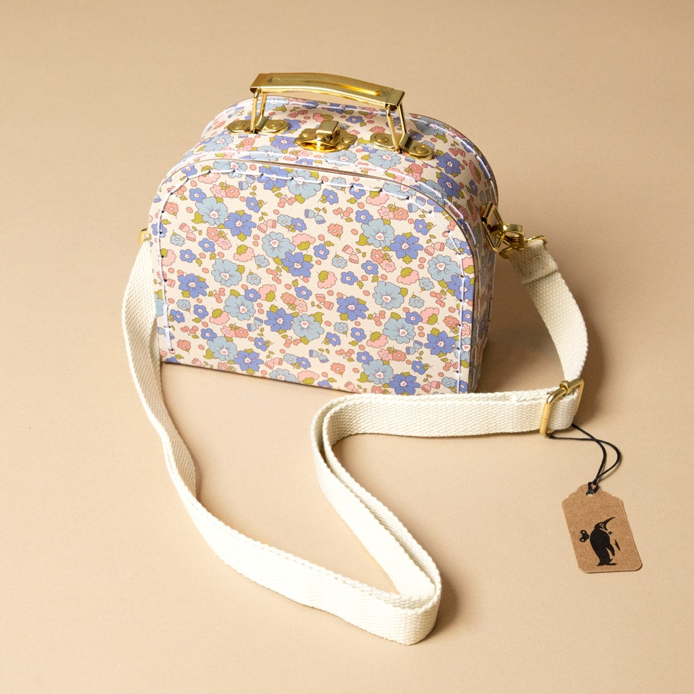 little-cross-body-case-liberty-blue Floral patterned handbag with a strap on a beige background