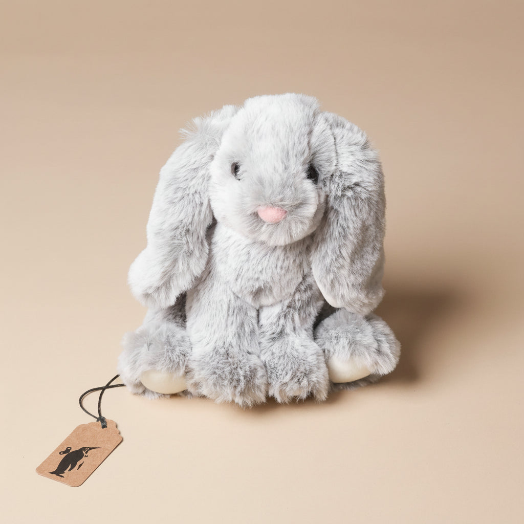 little-lottie-bunny-grey plush bunny toy with a brown tag on a beige background