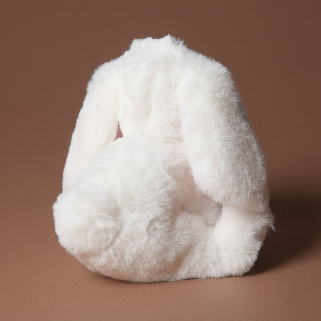 little-lottie-bunny-white fluffy toy on a brown background