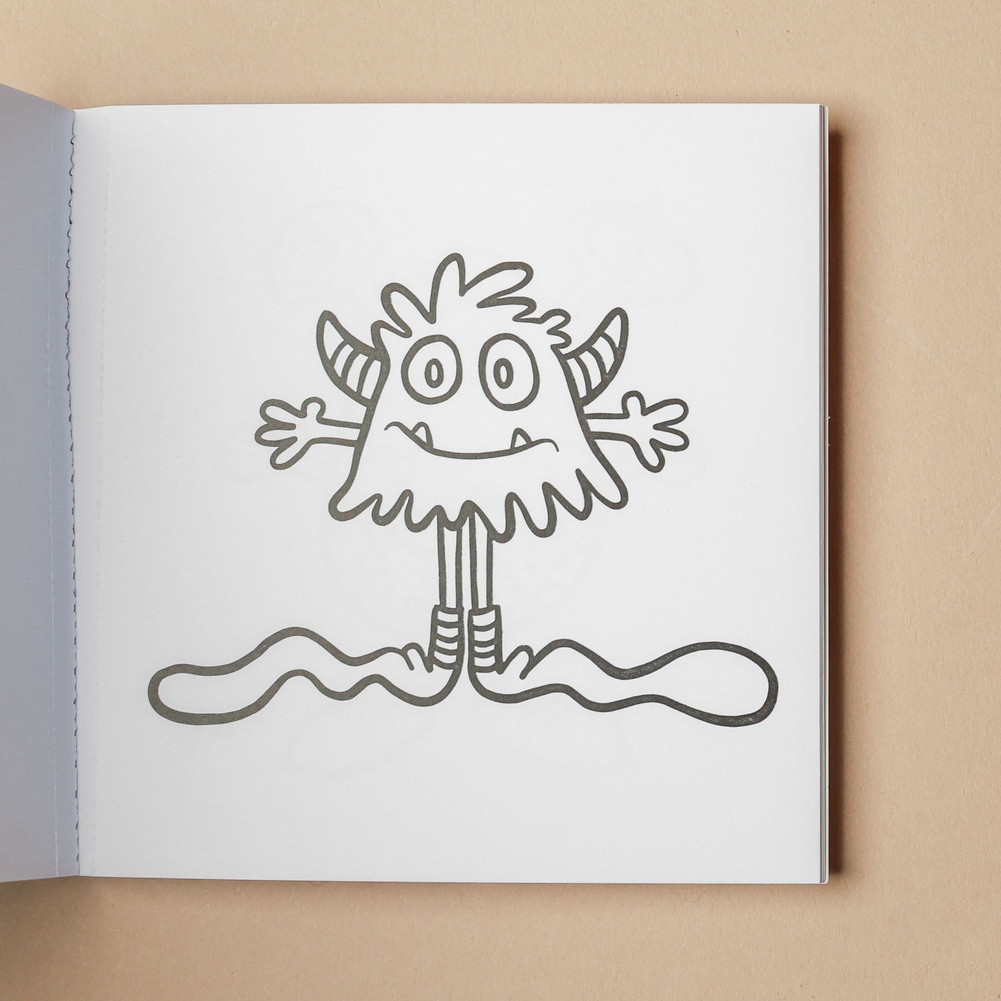 Illustration of a cartoon monster on a white page with a beige background