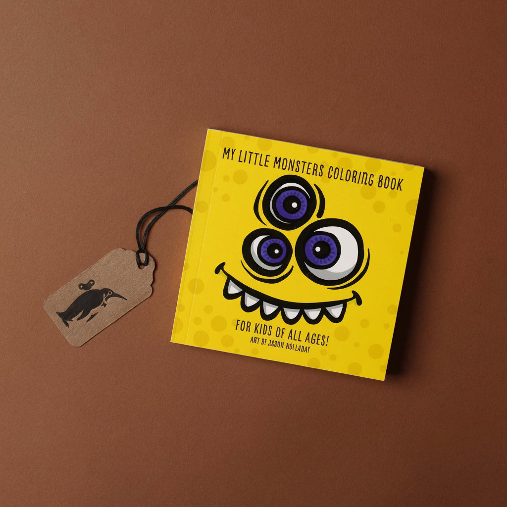 Coloring book with monster design on a brown background