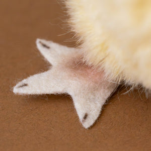 close-up-of-felted-blush-colored-feet-of-yellow-hen-chick