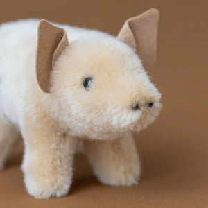 blush-colored-little-piggy-stuffed-animal-standing-with-triangled-sueded-ears-snout-and-clear-eyes
