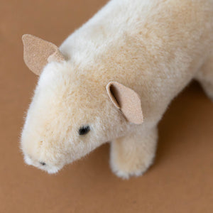 above-view-of-blush-colored-little-piggy-stuffed-animal-standing-with-triangled-sueded-ears-showing-quality-of-craftsmanship