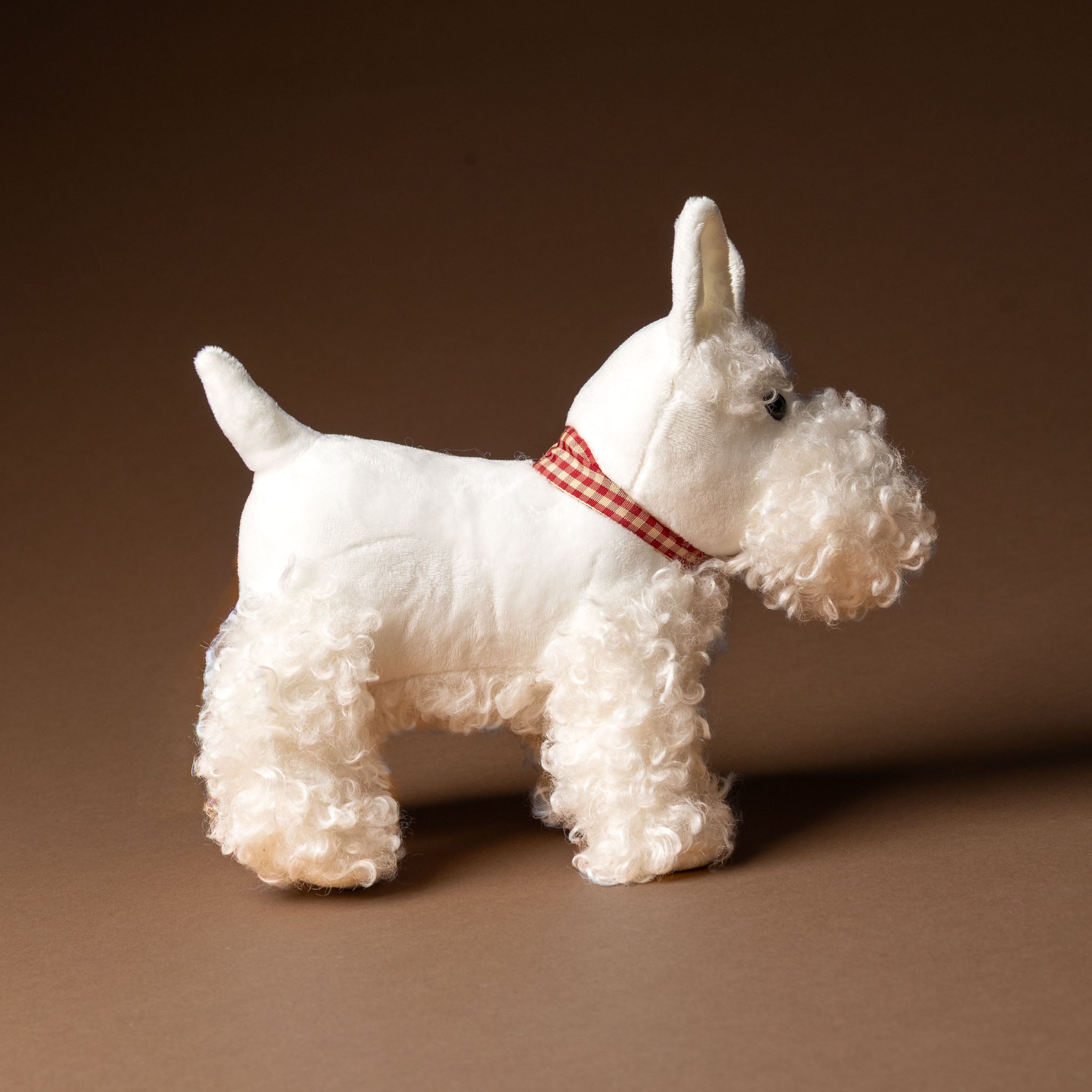 lola-the-dog White dog figurine with a red collar on a brown background