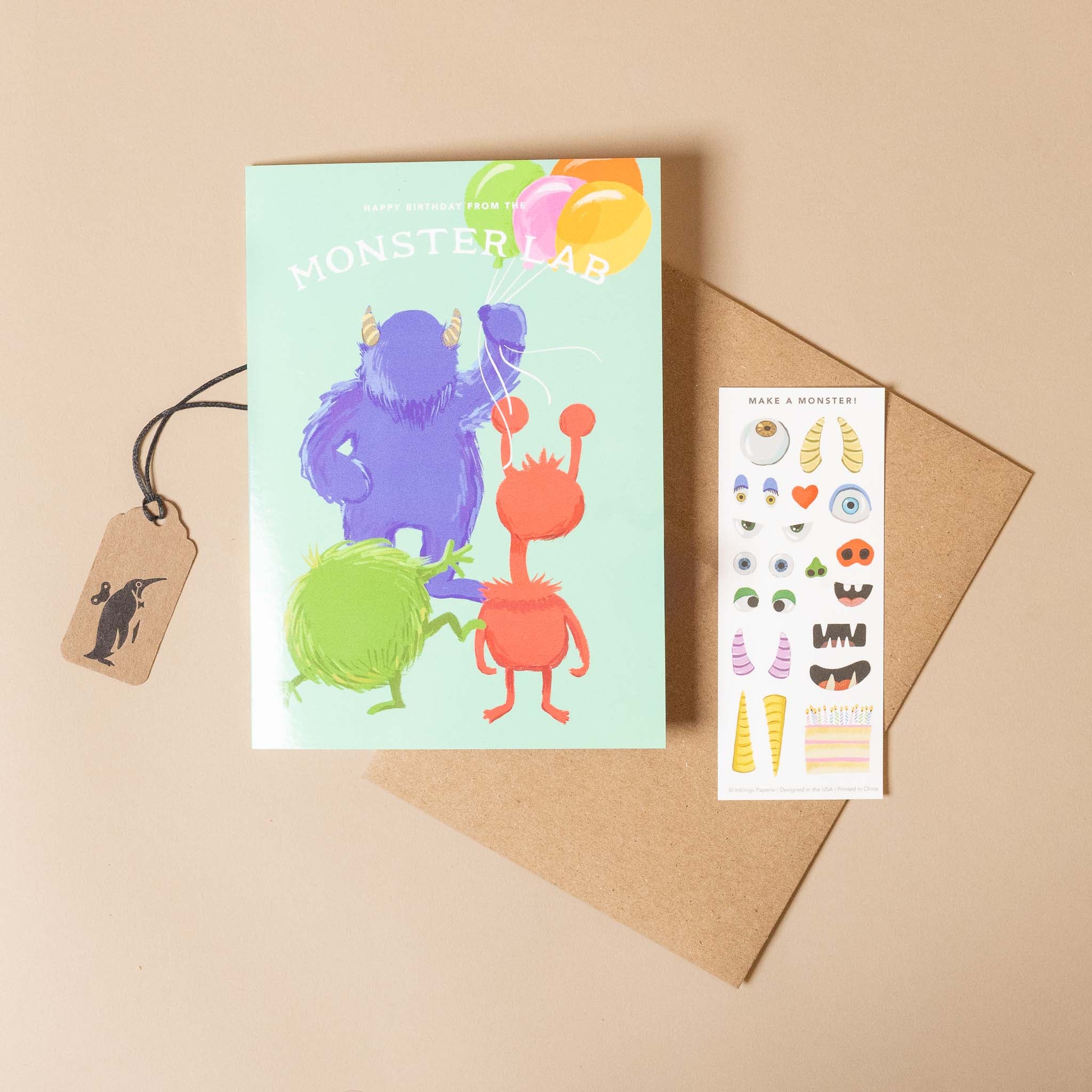 Colorful monster-themed card with stickers on a beige background