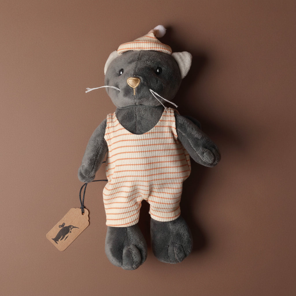malo-the-cat Stuffed toy cat in a striped outfit and hat on a brown background