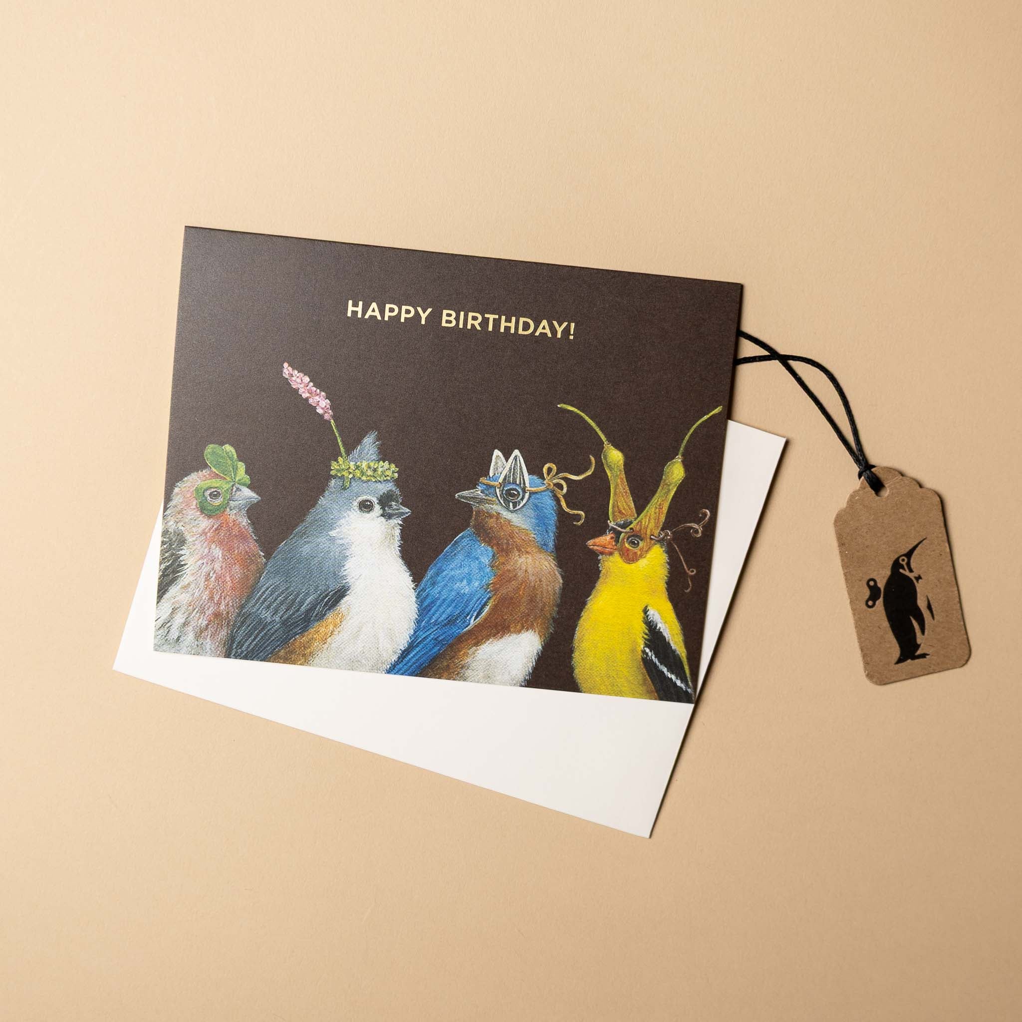 Birthday card with illustrated birds and a tag on a beige background
