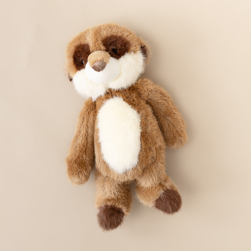 A plush toy shaped like a small brown and white beaver or nutcracker, photographed against a plain warm beige background.