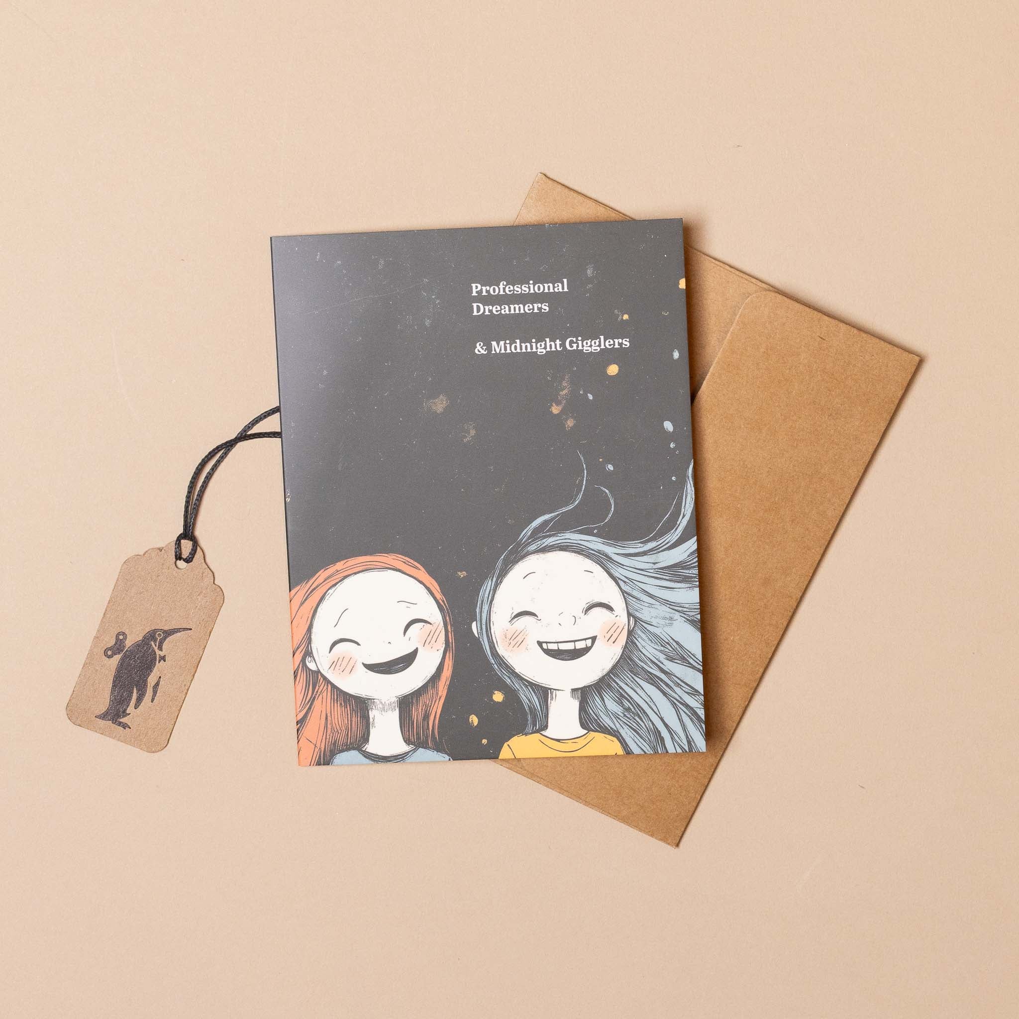 midnight-gigglers-greeting-card Greeting card with two smiling faces on a beige background