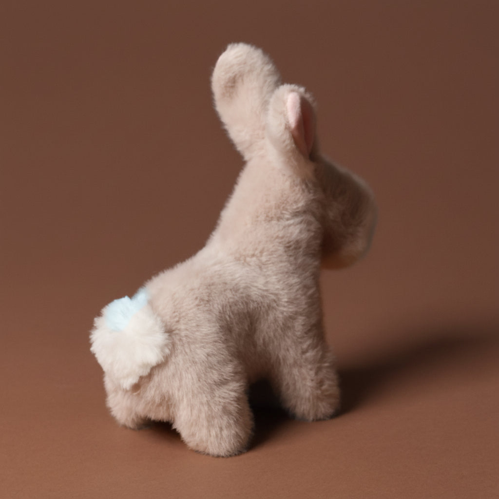 Plush toy muzzle-bernadette-bunny-smalon a brown background