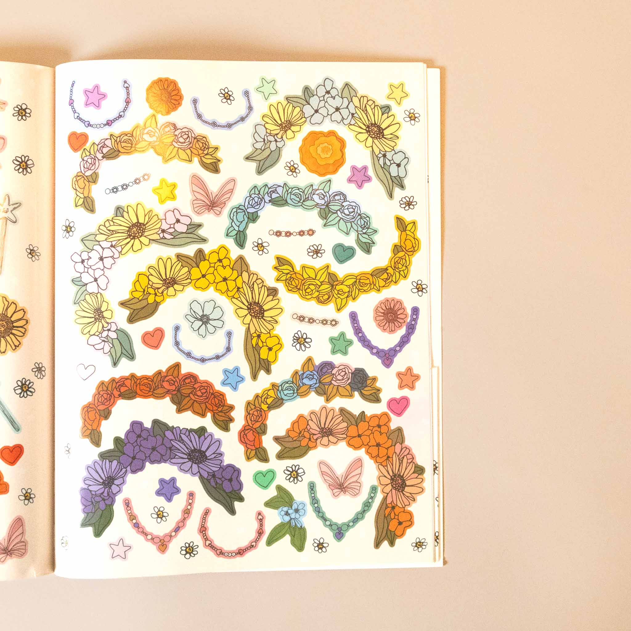 my-sticker-storybook-fairies-and-unicorns Colorful illustrations of floral wreaths, necklaces, and butterflies on a beige background