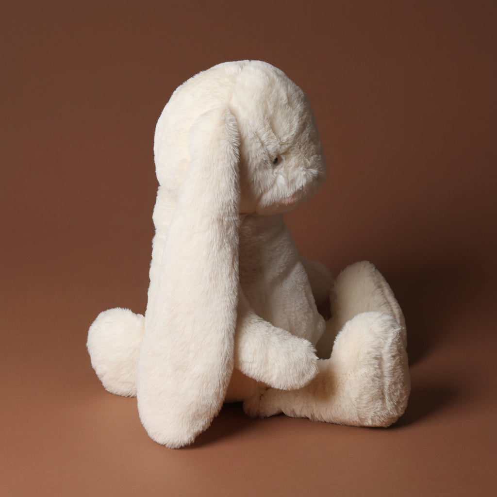 plush nibbles-bunny-cream-large toy on a brown background
