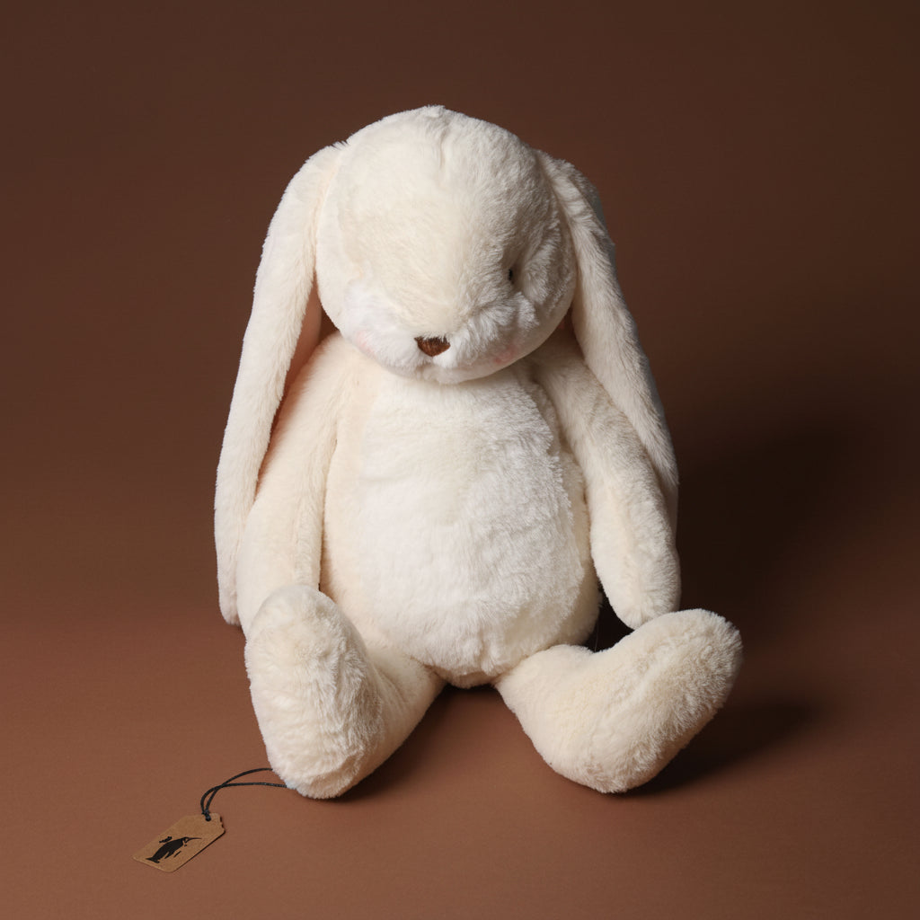 plush nibbles-bunny-cream-large toy on a brown background