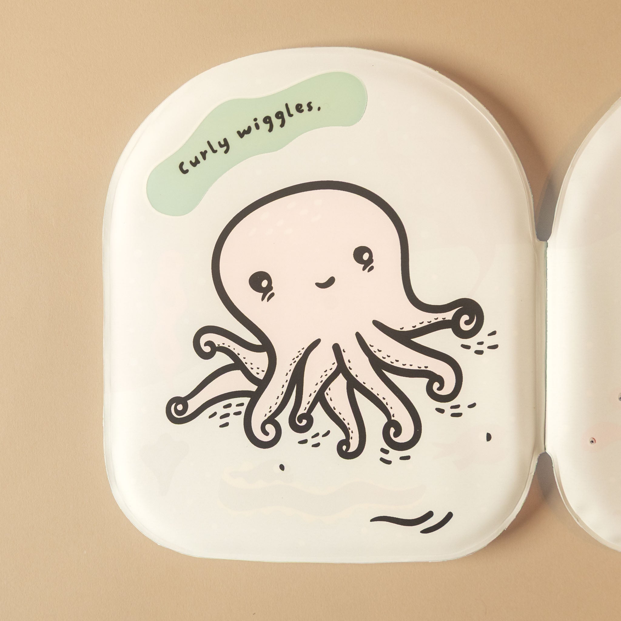 A white oval octopus-friends-bath-book with a cute octopus illustration and a light green speech bubble that says 'Curly wiggles.' on a warm beige background.