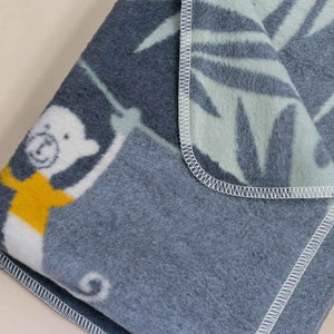 folded-blanket-with-monkey-detail-blanket-stitch-edge