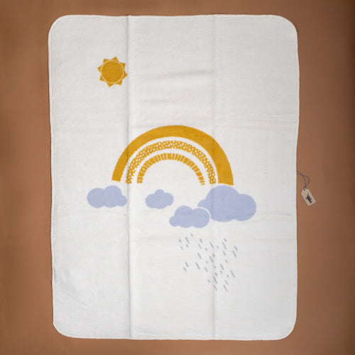organic-cotton-baby-blanket-yellow-rainbow-and-sun-with-blue-grey-clouds-and-raindrops-on-cream-backdrop