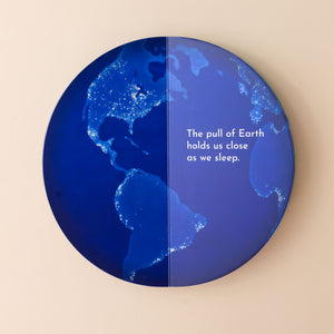 blue-earth-at-night-with-lighted-areas-on-land-text-the-pull-of-the-Earth-holds-us-close-as-we-sleep-book-circular-shaped