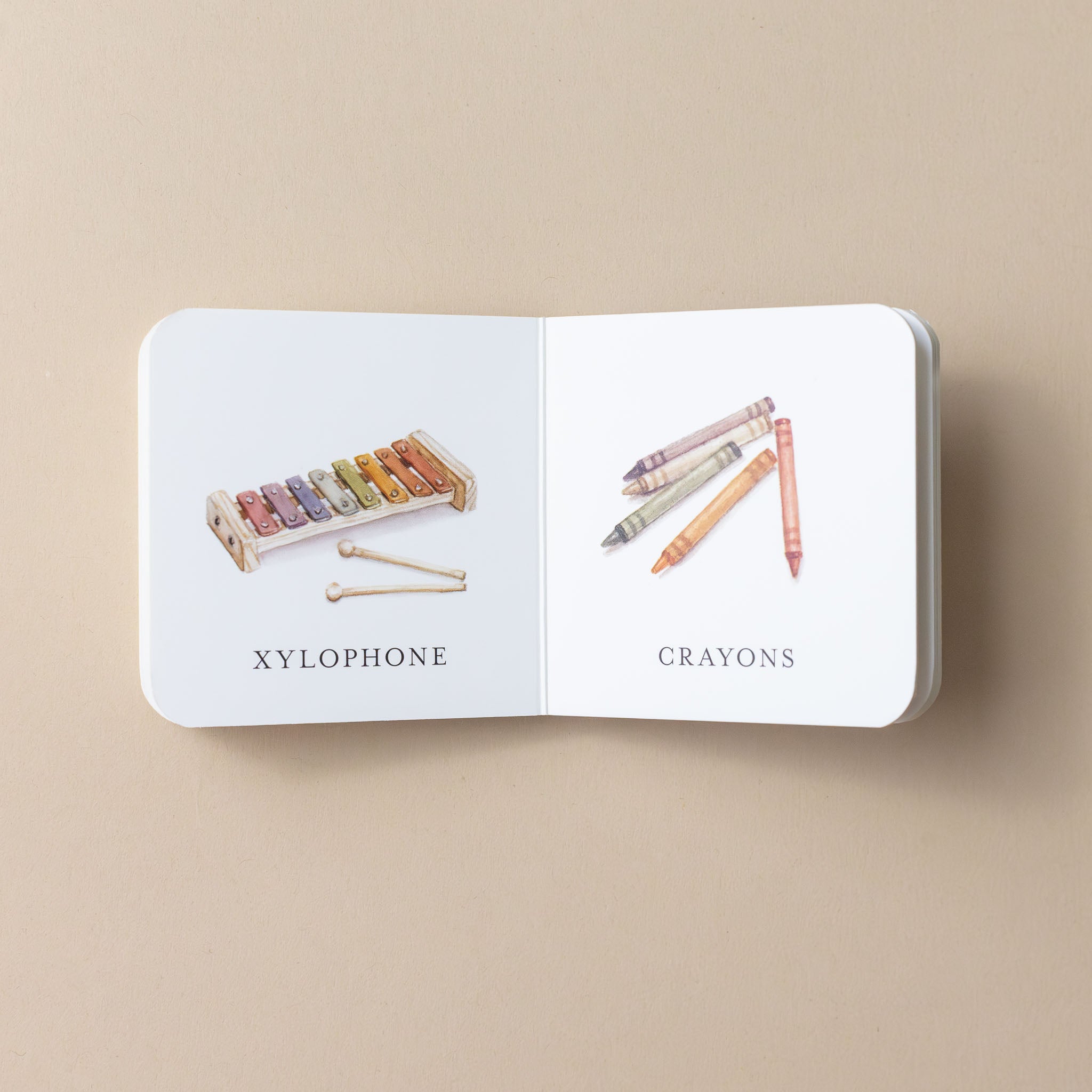 our-very-little-library-box-interior-page-with-text-and-illustration-of-xylophone-and-crayons