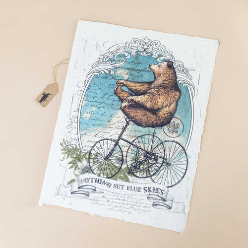 paper-print-blue-skies-with-a-bear-atop-a-tricycle-carefreely-riding-through-blue-skies
