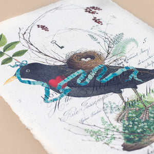 detail-of-bird-with-blue-ribbon-softly-laying-over-red-heart-with-next-on-its-back