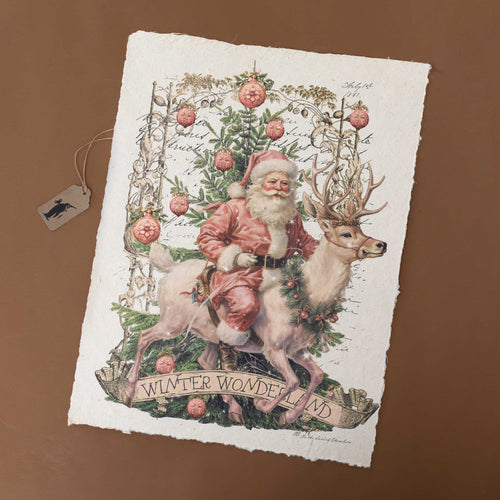 paper-print-winter-wonderland-with-santa-on-a-reindeer-surrounded-by greenery-ornaments-atop-background-of-faint-writing