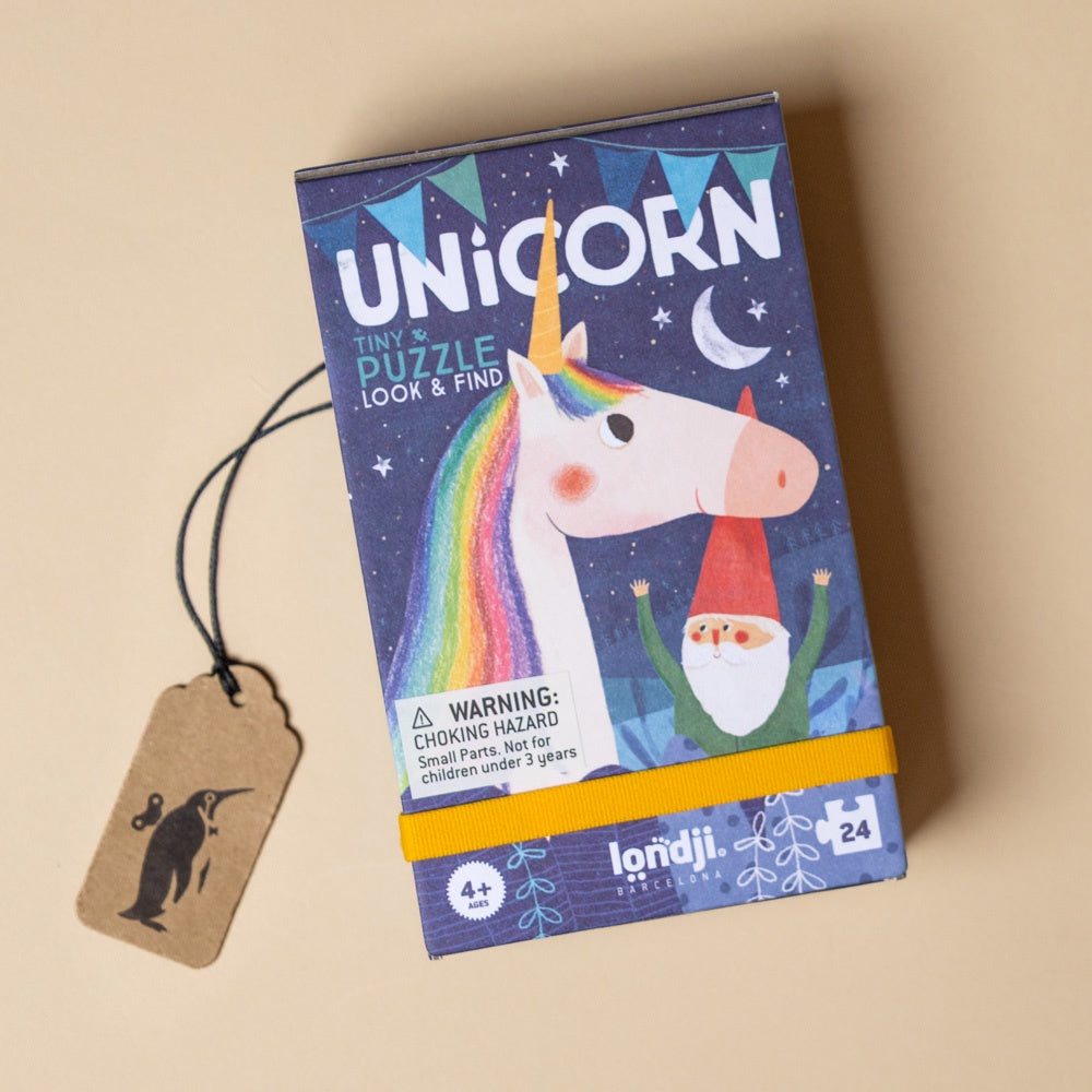 petite-24-piece-observation-puzzle-unicorn Unicorn-themed puzzle box with a tag on a beige background