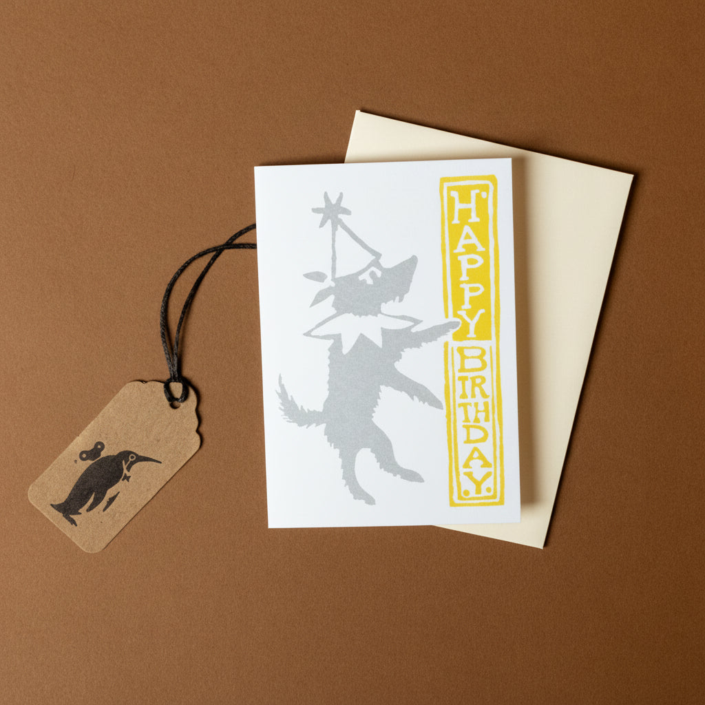 petite-birthday-dog-greeting-card with 'Happy Birthday' text and a tag on a brown background
