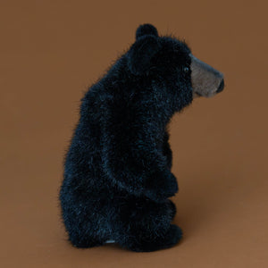 petite-black-bear-stuffed-animal-sitting-with-tan-snout-side-arm