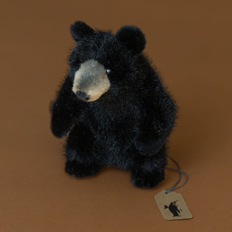 petite-black-bear-stuffed-animal-sitting-with-tan-snout