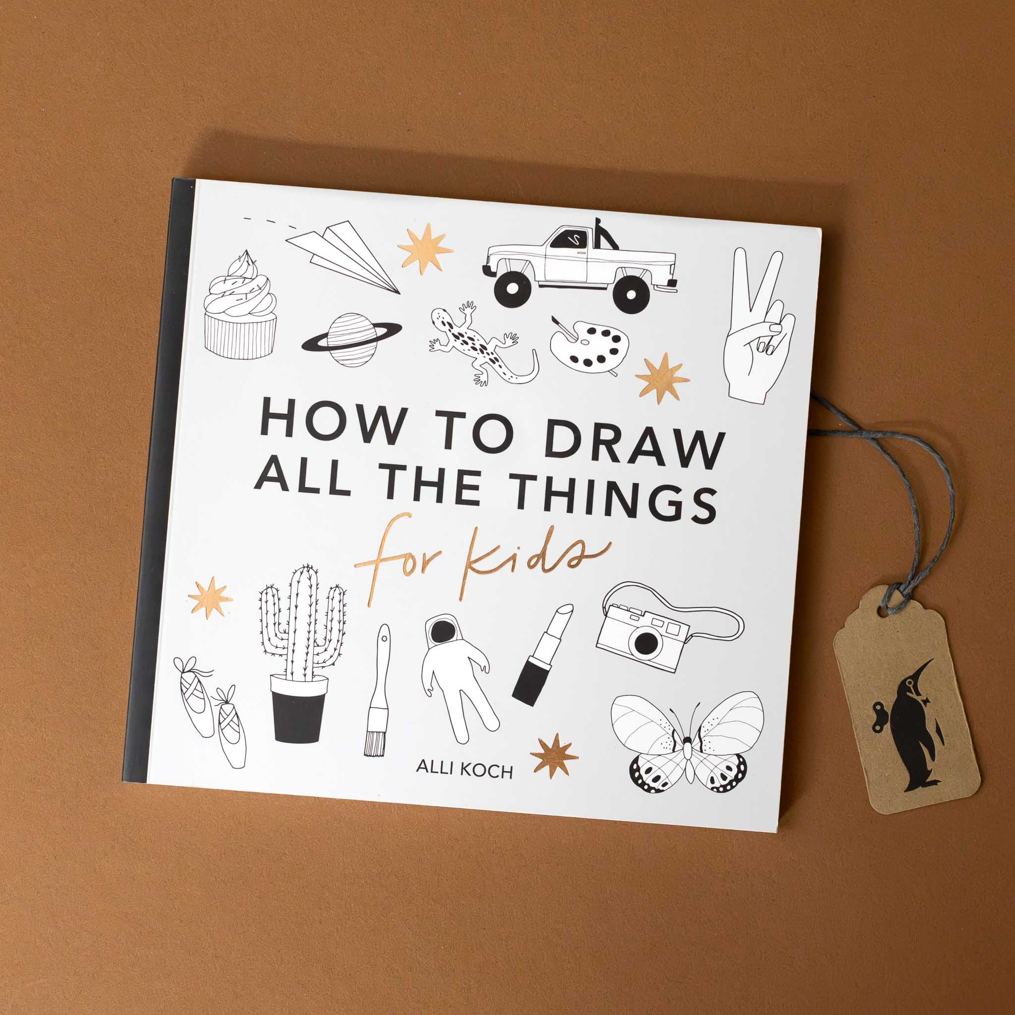 petite-how-to-draw-all-the-things-for-kids-grey-book-cover-with-black-white-images-of-cupcake-paper-airplane-saturn-lizard-truck-pallette-hand-ballet-shoes-cactus-paint-brush-spacesuit-lipstick-camera-butterfly-with-gold-foil-stars-and-detail