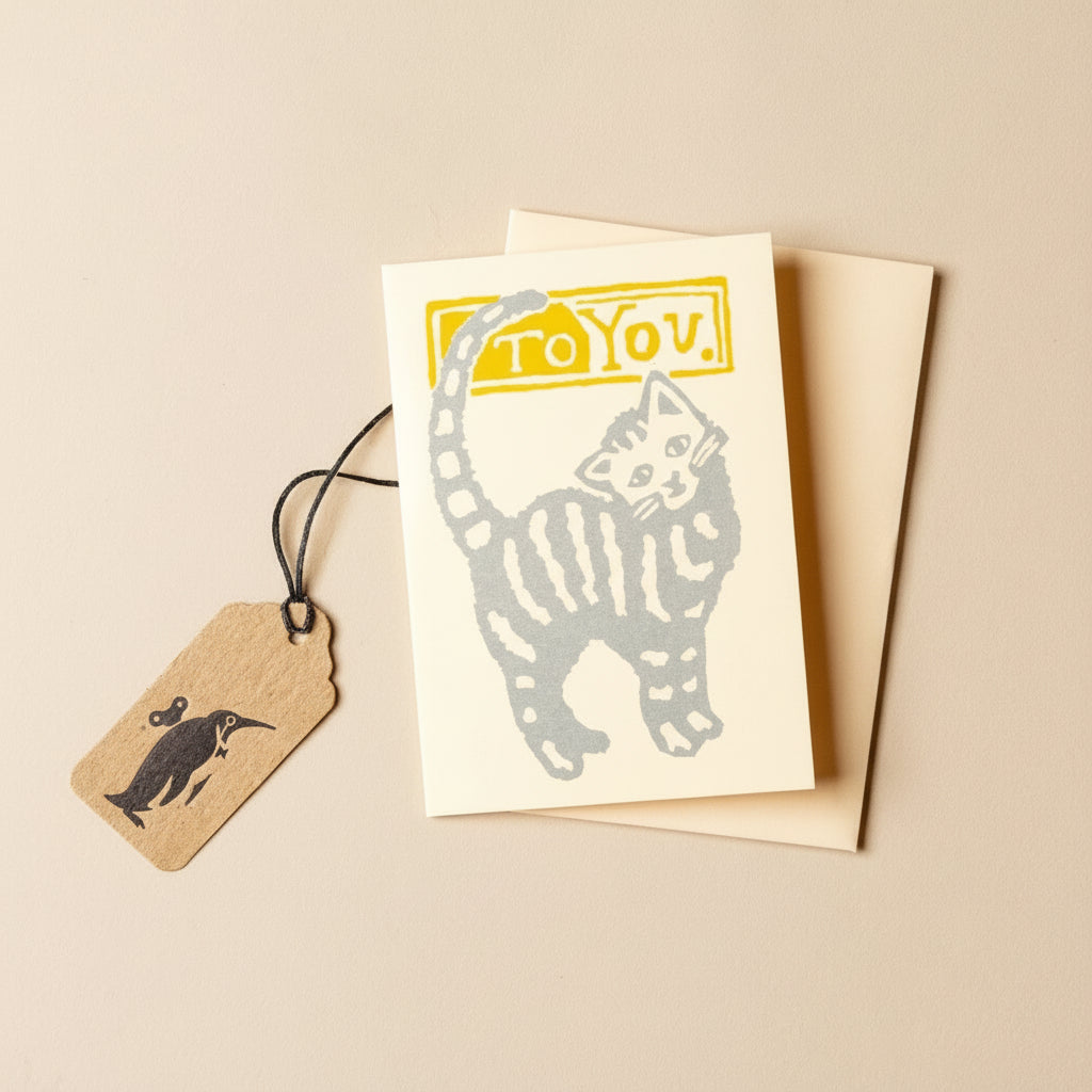 petite-kitten-greeting-card with cat illustration and 'To You' text, accompanied by a tag on a beige background