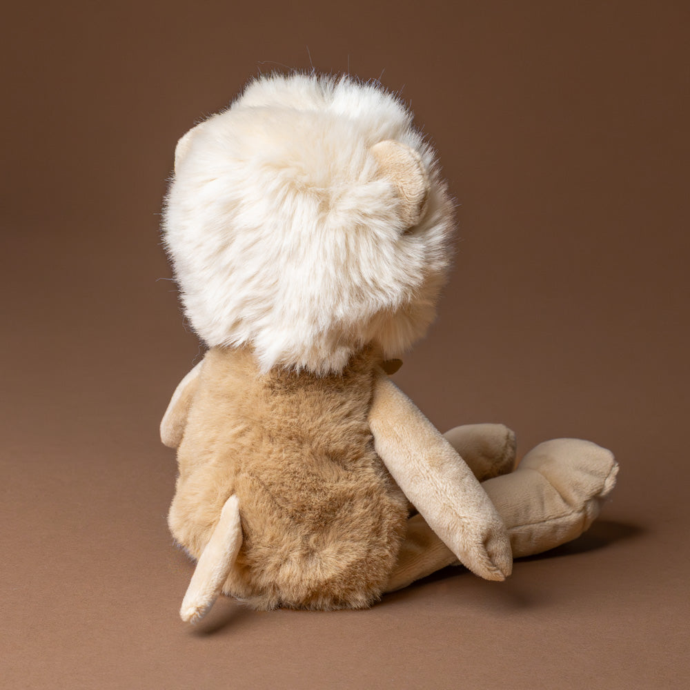 petite-lion-cub Plush lion toy on a brown background