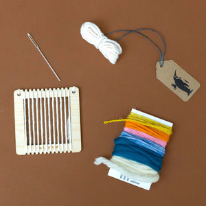petite-loom-needle-ochre-pink-orange-sky-blue-deep-blue-and-white-yarn-along-with-finishing-yarn
