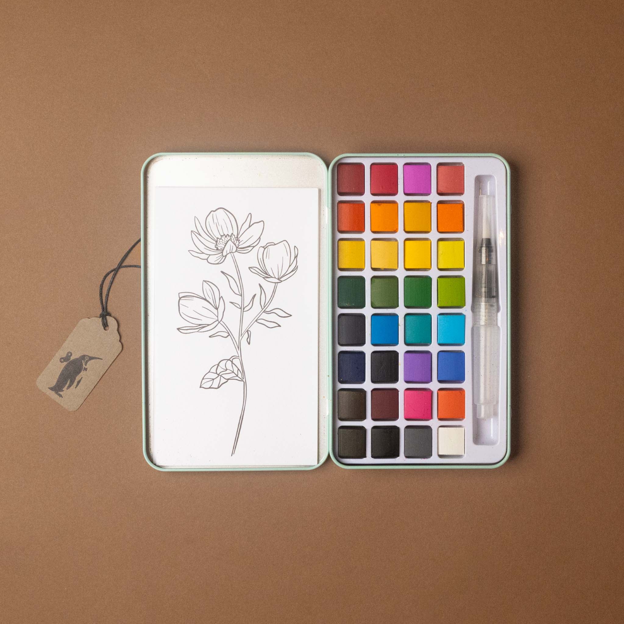 petite-watercolor-painting-kit-wildflower-meadow set with a floral illustration on a brown background