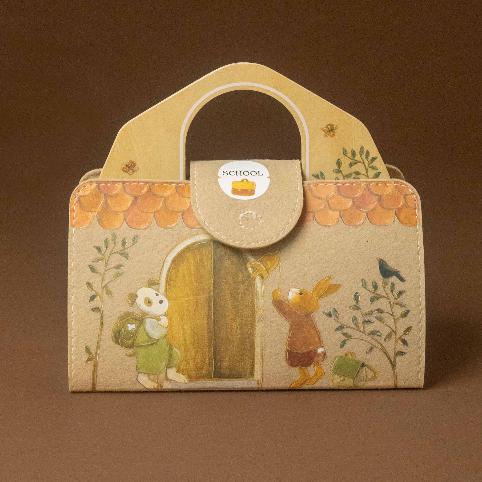 A small structured petits-amis-schoolhouse-play-setwith a top handle, featuring a beige background and an illustrated scene of a rabbit at a door with a bear, floral border details, and a circular 'SCHOOL' sticker near the handle.