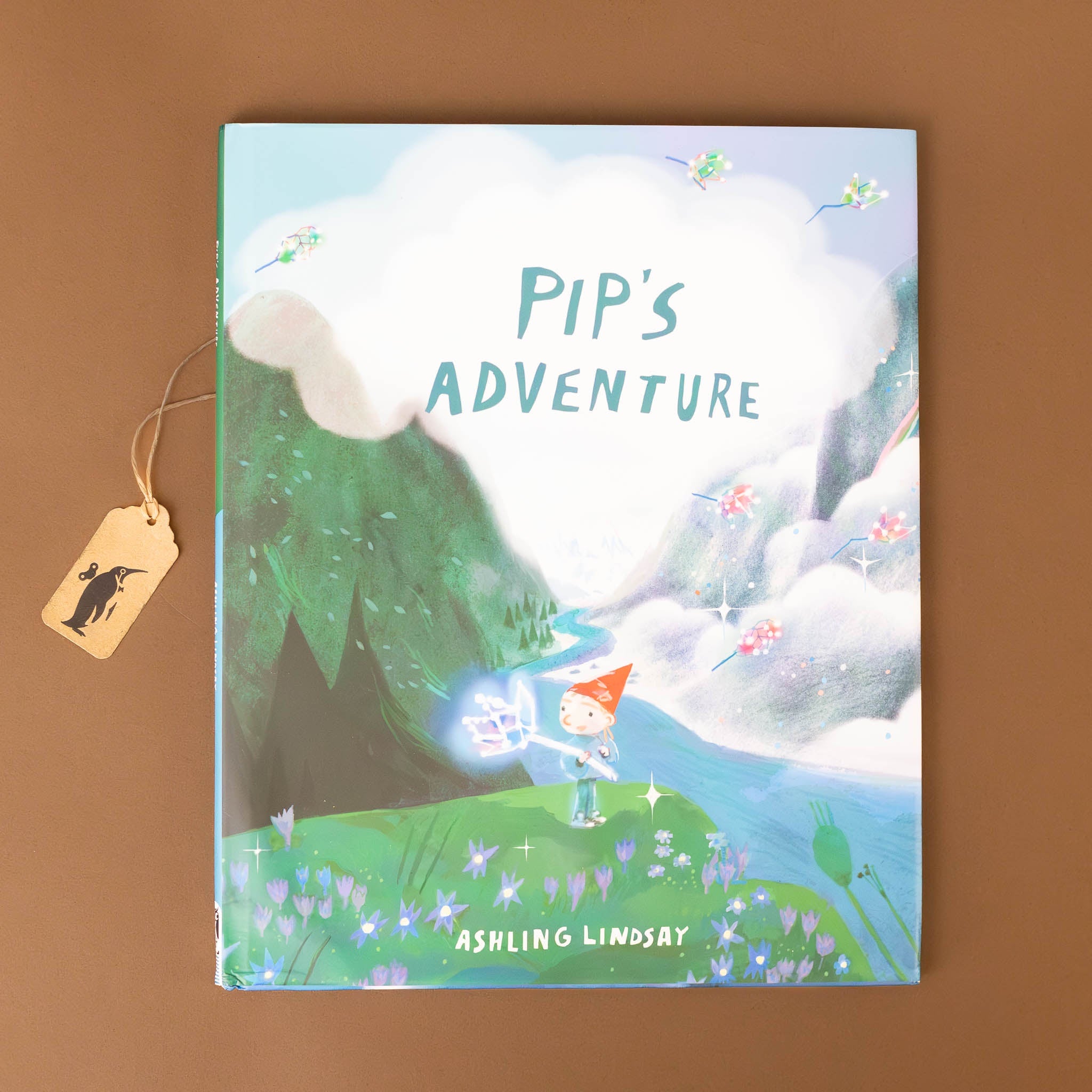 pips-adventure-book-cover-with-a-fairy-in-a-grassland-next-to-mountains-with-twinkling-flowers