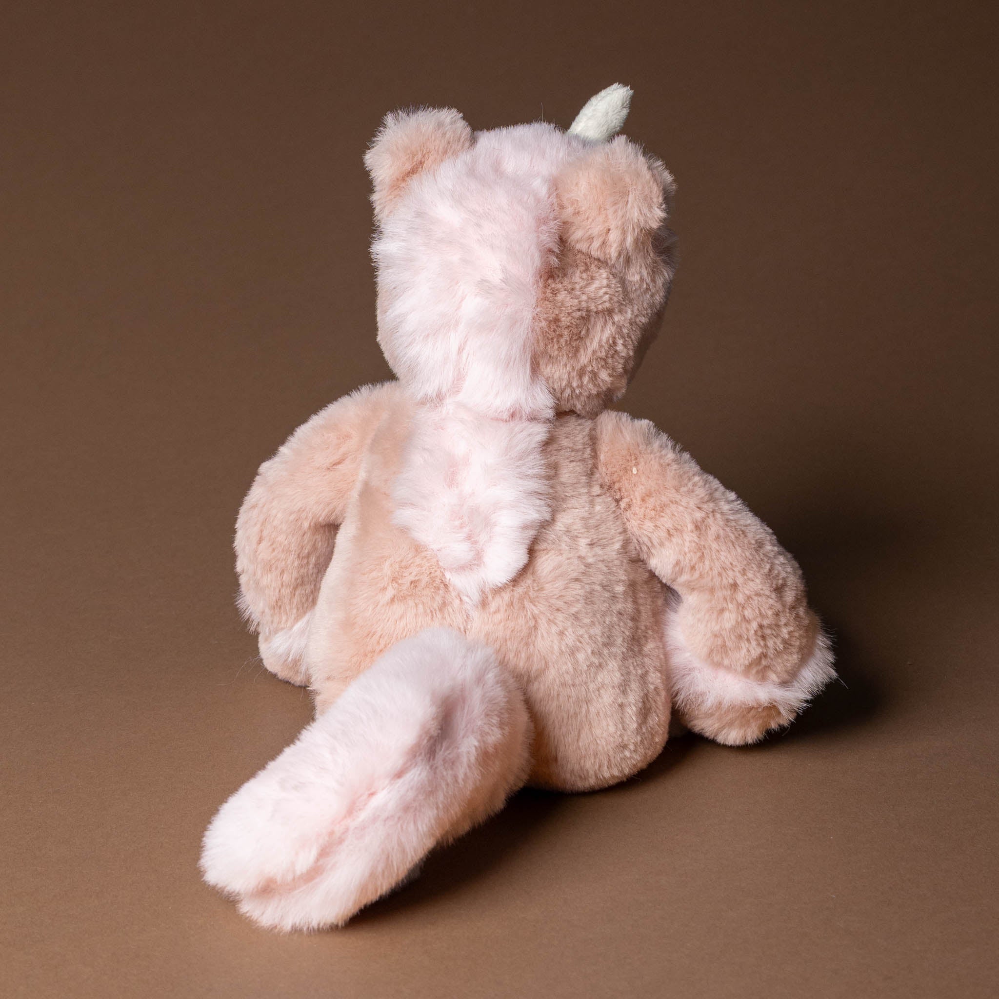 pirouette-the-unicorn Plush toy with a unicorn design on a brown background