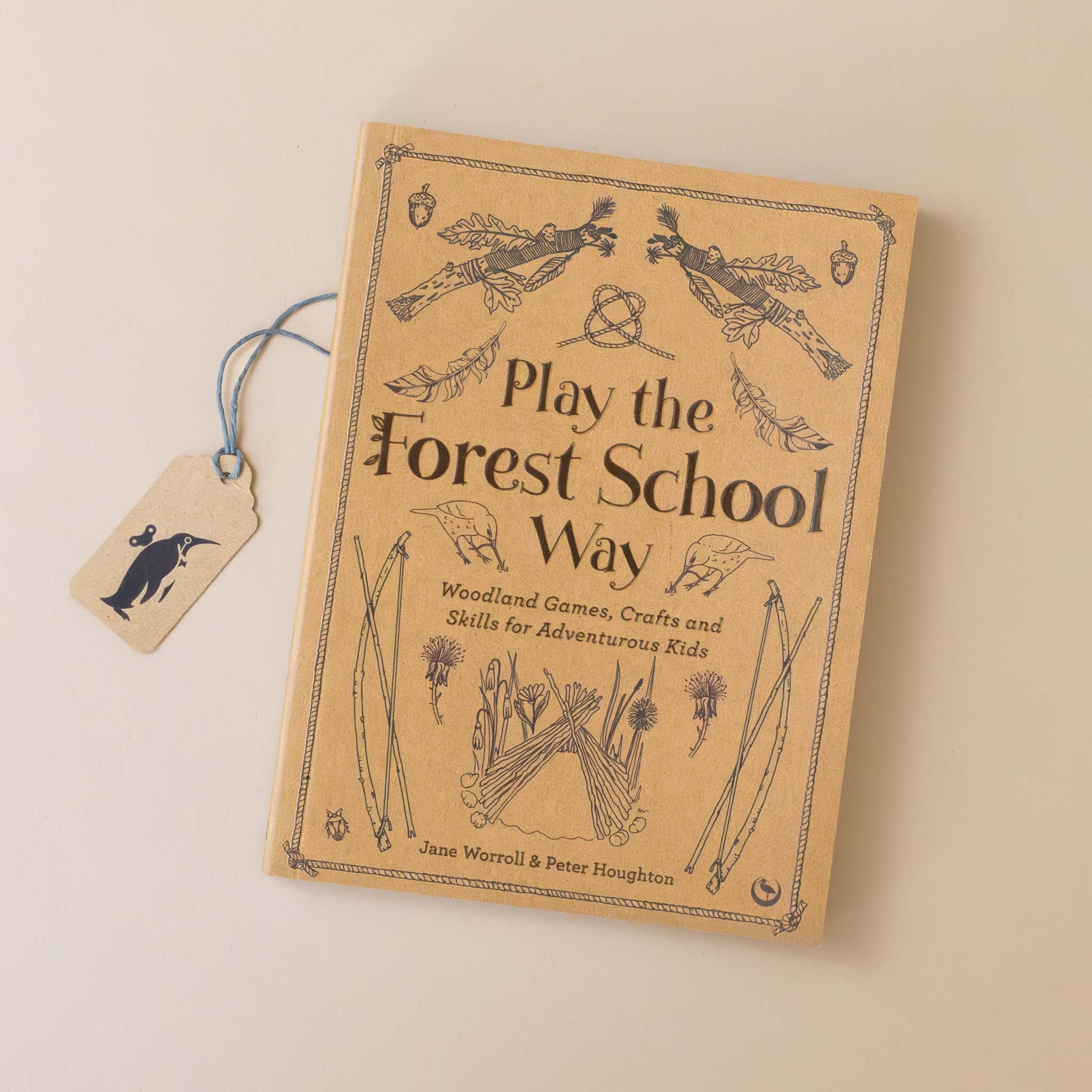 play-the-forest-school-way-book-cover-in-kraft-paper-color-with-bow-and-arrow-and-other-tools