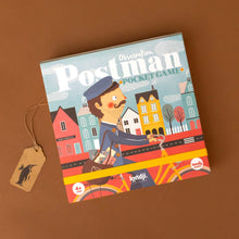 Load image into Gallery viewer, postman-pocket-game-box-with-postman-carrying-the-letters-through-town-on-a-bike