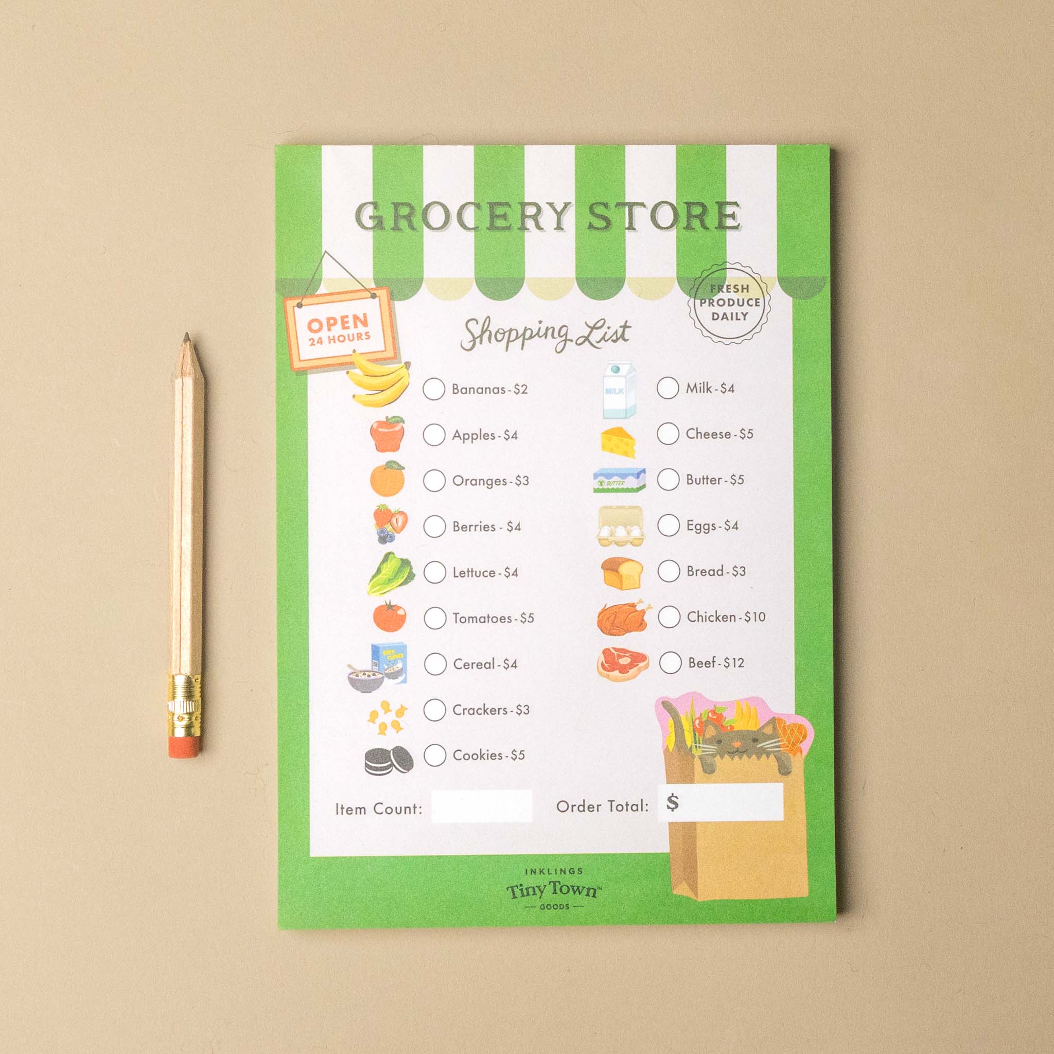 A green and white striped grocery store themed shopping list notepad on a beige background, styled with a wooden pencil next to it. The notepad features illustrations of various grocery items and the text 'GROCERY STORE' and 'Shopping List'.
