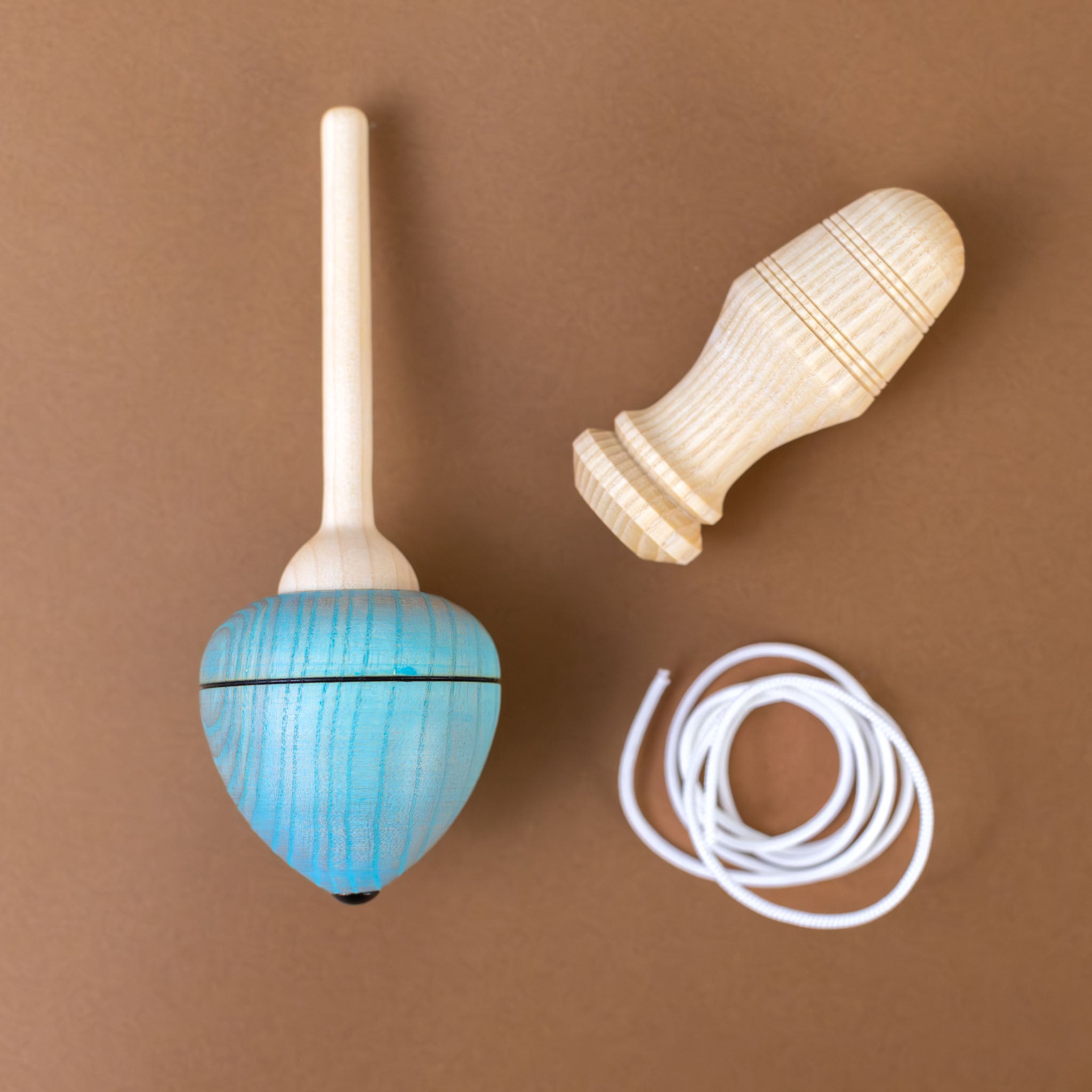 pull-string-wooden-spinning-top-with-blue-base-pulled-into-functional-pieces