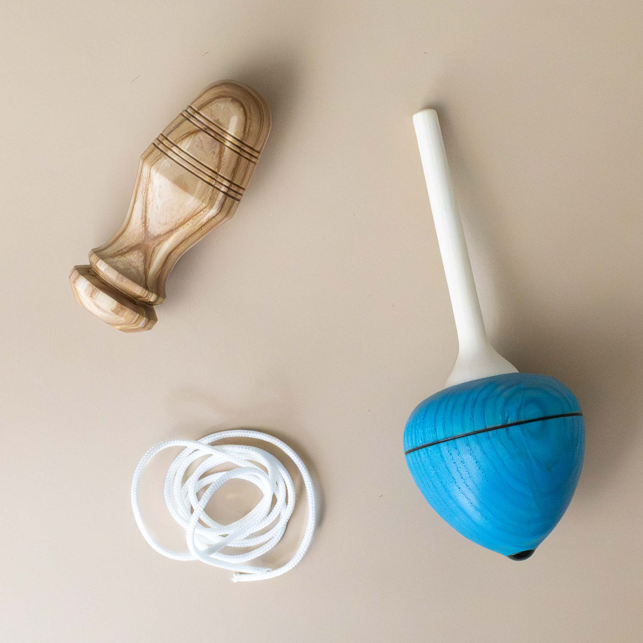 pull-string-wooden-spinning-top-with-blue-base-pulled-into-functional-pieces