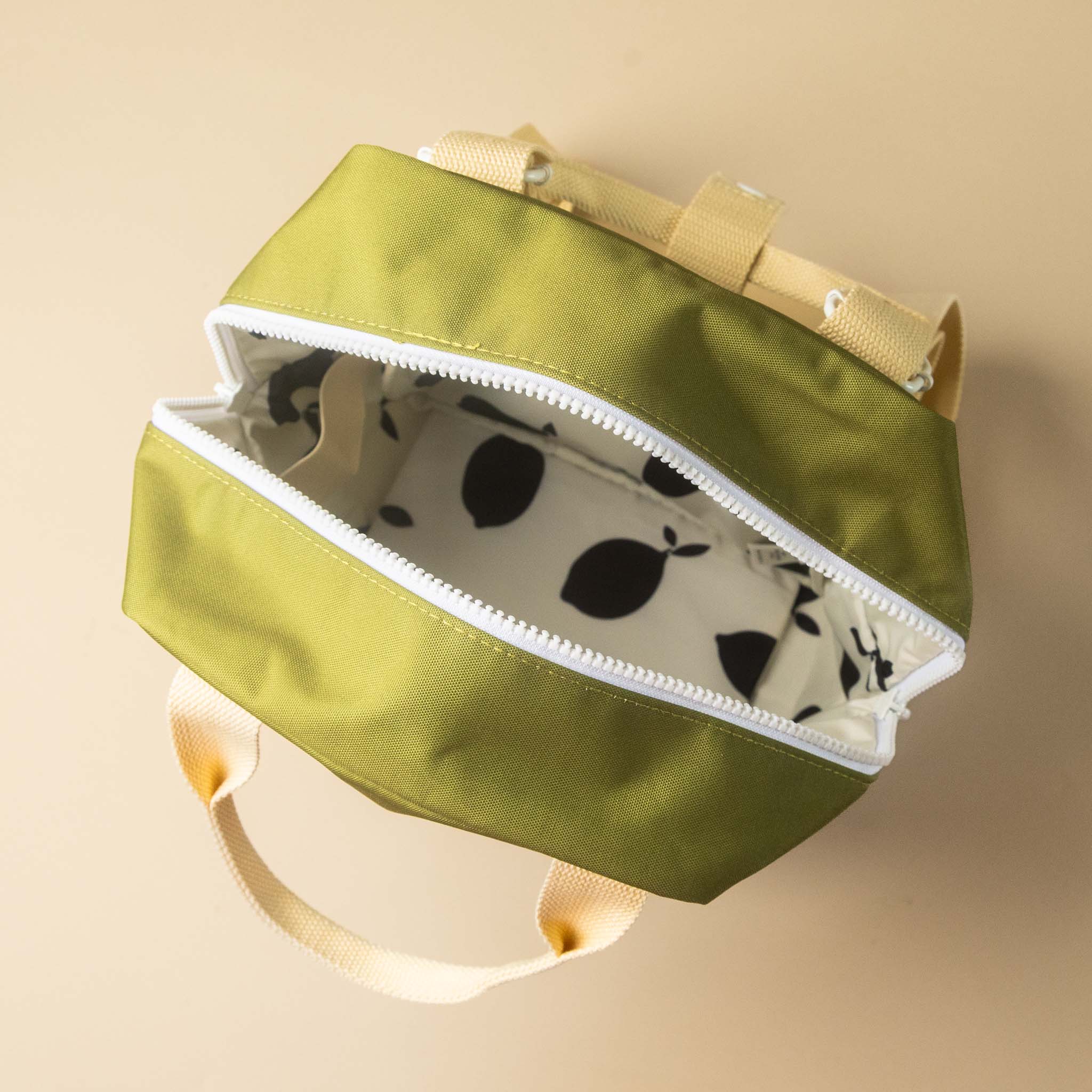 recycled-lemon-tree-envelope-backpack-small-grassy-field-opening