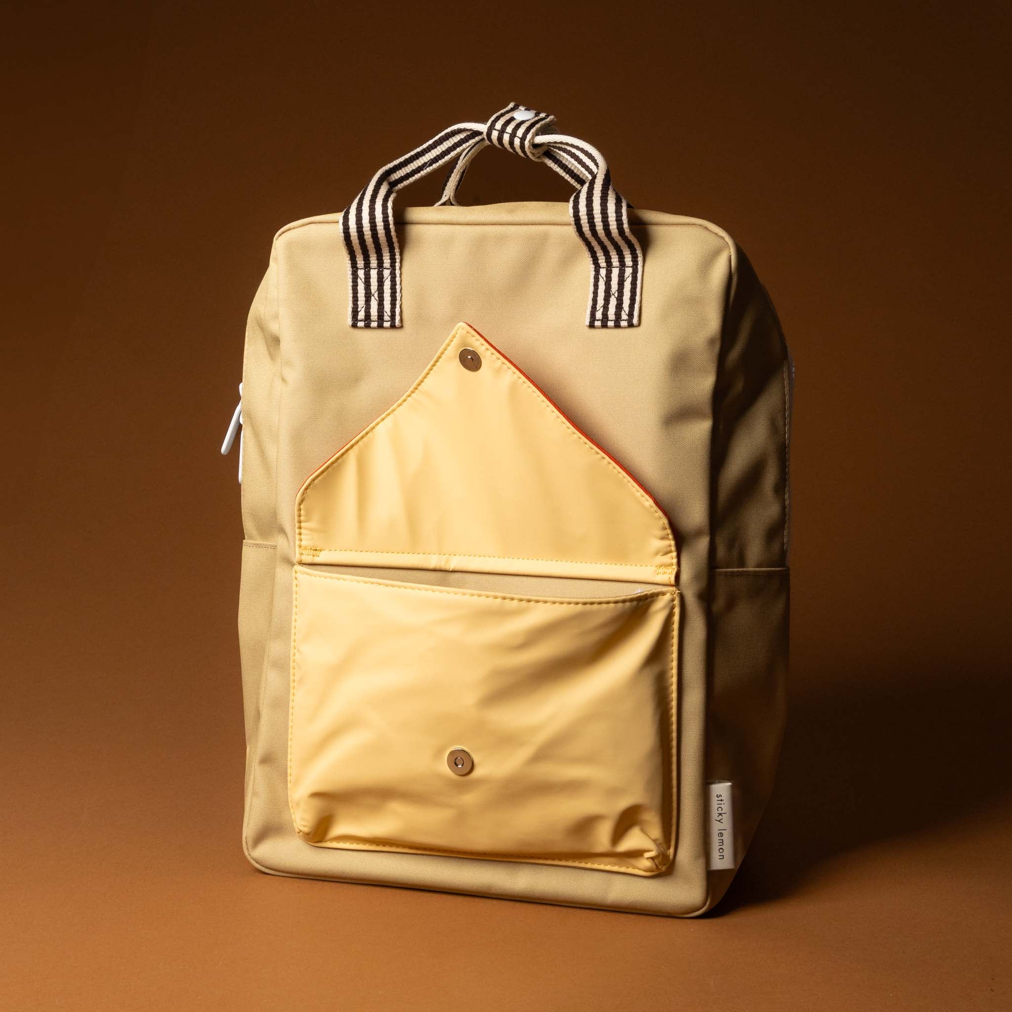 recycled-wonders-envelope-backpack-large-sandy-beach-with-a-red-pocket-open-black-striped-straps