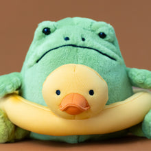 Load image into Gallery viewer, ricky-green-rain-frog-with-yellow-rubber-duckie-ring-stuffed-animal-with-a-pouting-face
